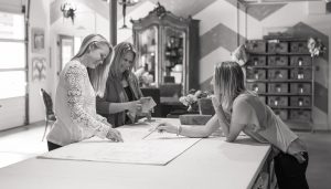 Elizabeth Robb, Dana Talbot, and Linnaea Keane working on a design project at the Elizabeth Robb Interiors studio