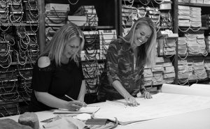 Dana Talbot and Elizabeth Robb working and laughing in the Elizabeth Robb Interiors studio